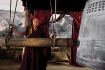 An Old Man Hitting A Bell