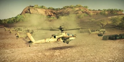 A desert camouflage Apache, landing near a line of fellow Apaches